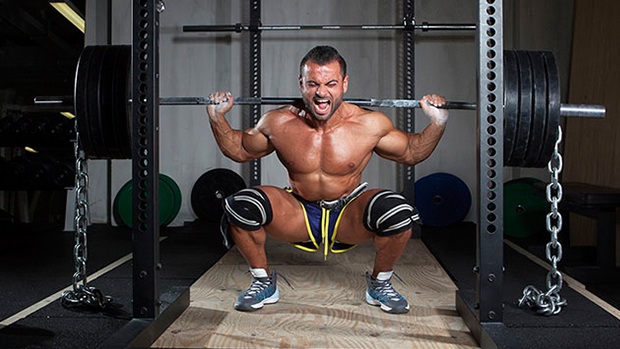 3 Day Powerlifting Workout--man squatting under bar